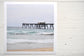 Pinch River unframed 17cm x 17cm Photographic Print on Paper Titled: Catherine Hill Bay Jetty. The subject of the print is the iconic Catherine Hill Bay Jetty from the beach, waves rolling in and beautiful aqua blue of the water in the background. Top view.