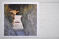 Pinch River unframed 17cm x 17cm Photographic Print on Paper Titled: Caves Beach #2. The subject of the print is looking through a cave opening with the sun reflecting on the cave wall. Top view.