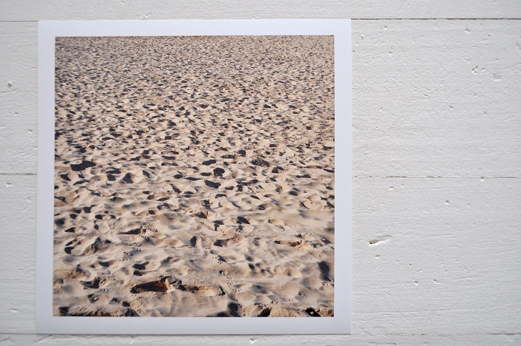 Pinch River unframed 17cm x 17cm Photographic Print on Paper Titled: A Day at the Beach. The subject of the print is footprints and seagull prints in the sand. Top view.