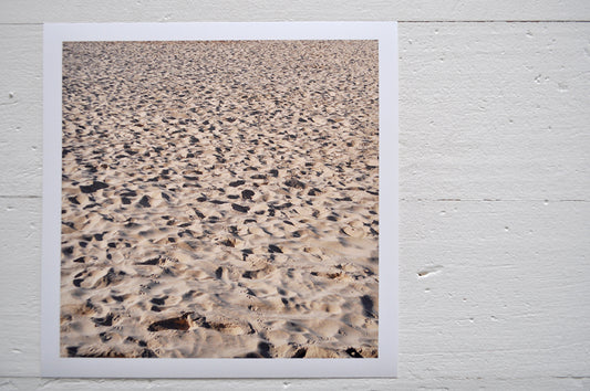 Pinch River unframed 17cm x 17cm Photographic Print on Paper Titled: A Day at the Beach. The subject of the print is footprints and seagull prints in the sand. Top view.