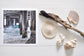 Pinch River unframed 17cm x 17cm Photographic Print on Paper Titled: Underneath the Jetty #3. The subject of the print is a close-up of the iconic Catherine Hill Bay Jetty from underneath, with the weather-worn timber pilings, waves crashing and beautiful aqua blue of the water in the background. Top view with sea shells and driftwood next to it to style the product image.