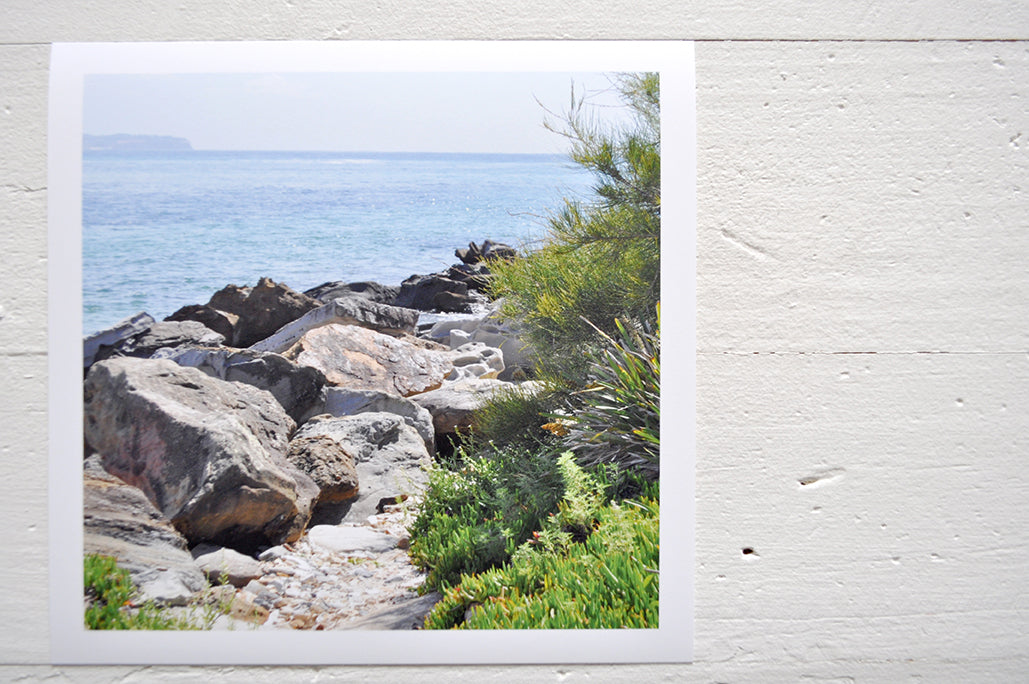 Pinch River unframed 17cm x 17cm Photographic Print on Paper Titled: Reids Reserve #3. The subject of the print is a coastal rocky outcrop looking out over the ocean. Top view.