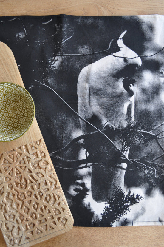 Pinch River handprinted halftone cockatoo tea towel. Top view.
