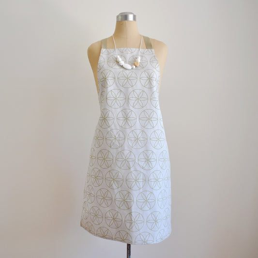 Pinch River bib apron / full apron in Flower of Life print, Spring Green on Silver Ash (colourway 1) on dressmakers dummy against a plain background. Front View.