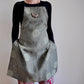 Model wearing Pinch River bib apron / full apron in Honeycomb print against a plain background. Front View.