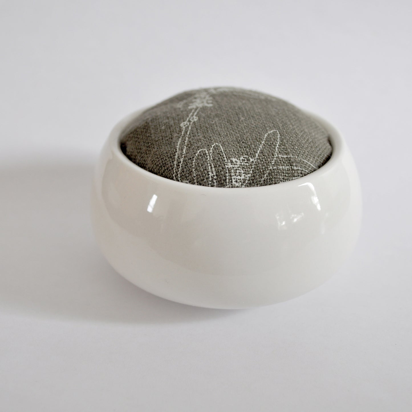 Pinch River ceramic pin cushion featuring Bottle Brush print in Moss Green (colourway 3). Side view.