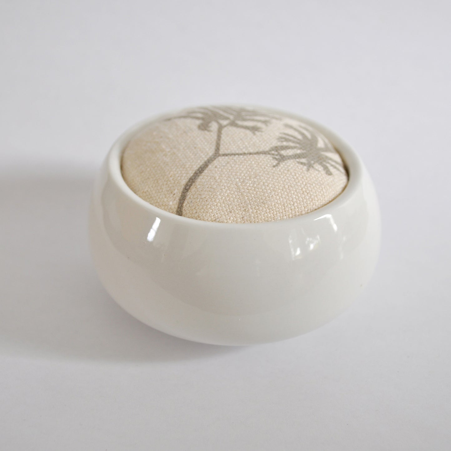 Pinch River ceramic pin cushion featuring Kangaroo Paw print in Aged Wood (colourway 2_v1). Side view.