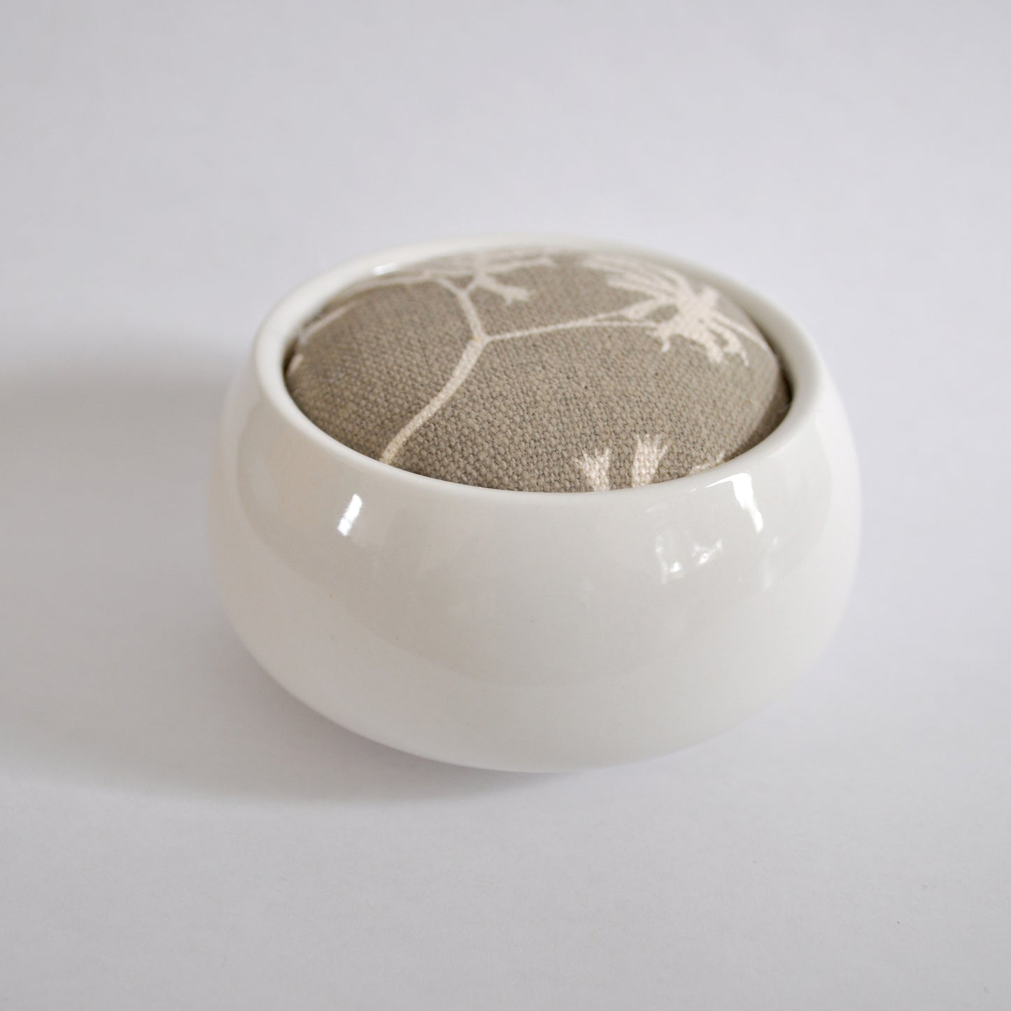 Pinch River ceramic pin cushion featuring Kangaroo Paw print in Aged Wood (colourway 2_v2). Side view.