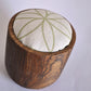 Pinch River teak pin cushion featuring Flower of Life print in Spring Green (colourway 1). Angled view.