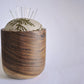 Pinch River teak pin cushion featuring Kangaroo Paw print in Desert Green (colourway 1). Side view. Product image is styled with pins.