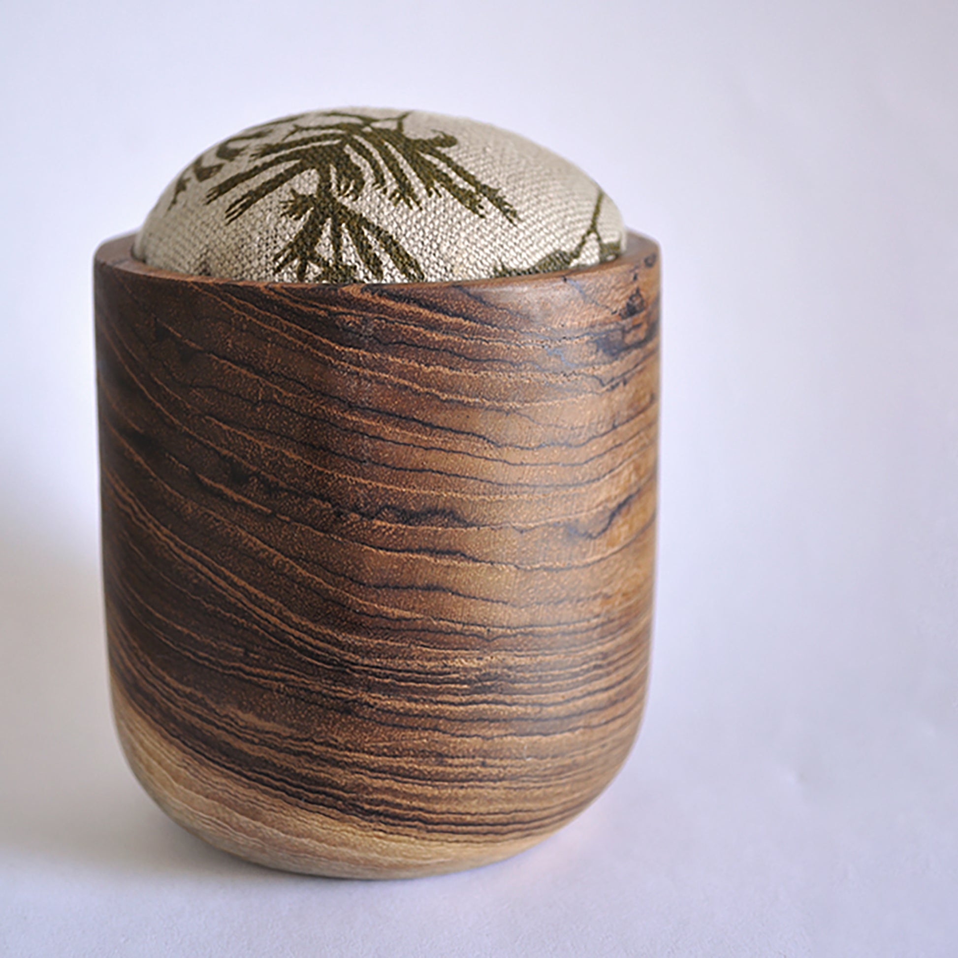 Pinch River teak pin cushion featuring Kangaroo Paw print in Desert Green (colourway 1). Side view.