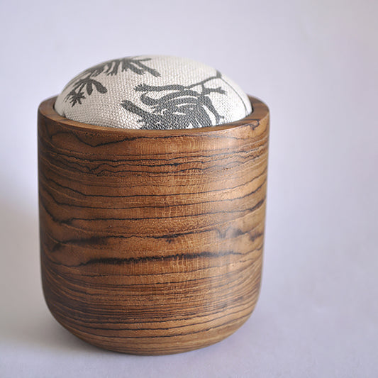 Pinch River teak pin cushion featuring Kangaroo Paw print in Tempest (colourway 3). Side view.