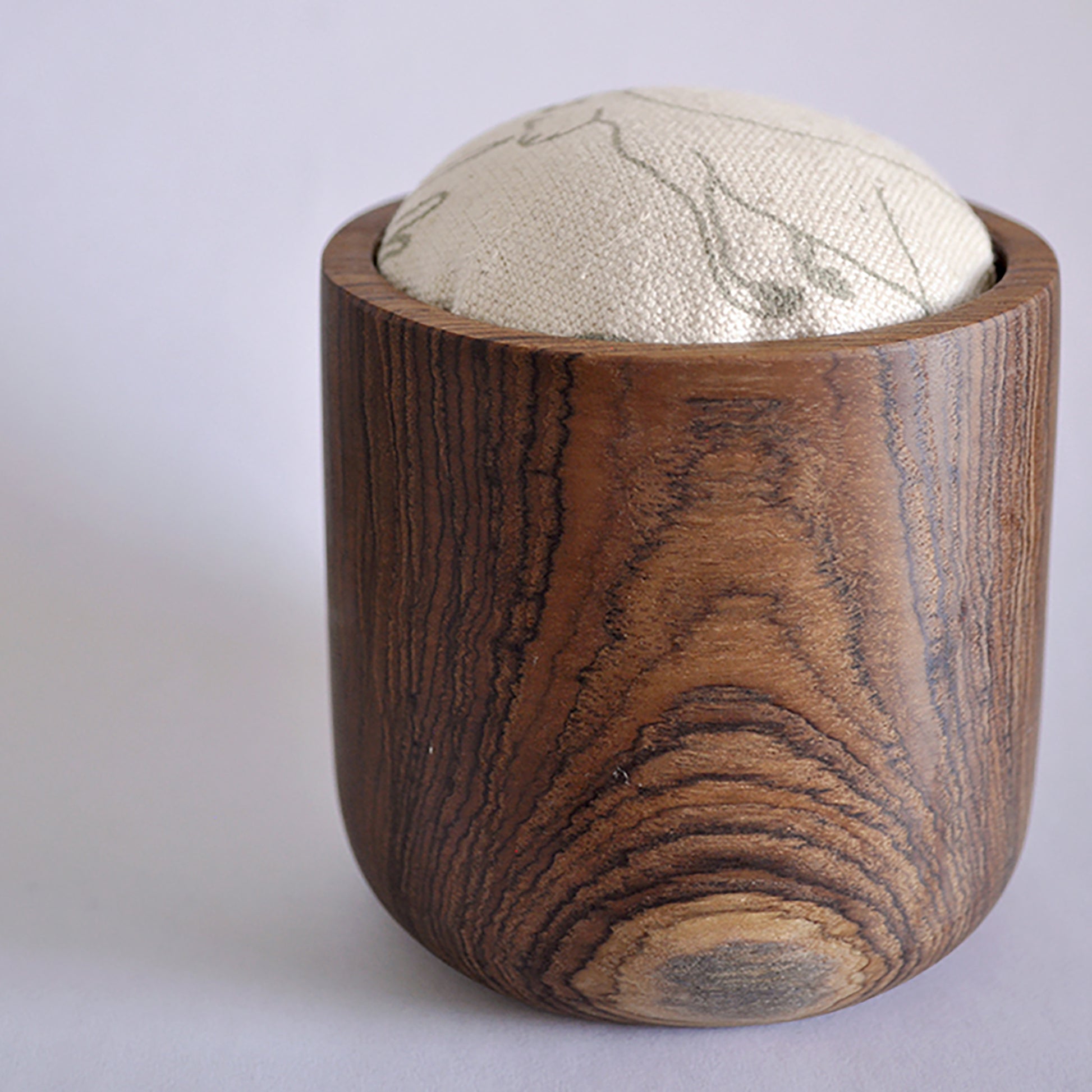 Pinch River teak pin cushion featuring Kangaroos print in Moss Green (colourway 2). Side view.