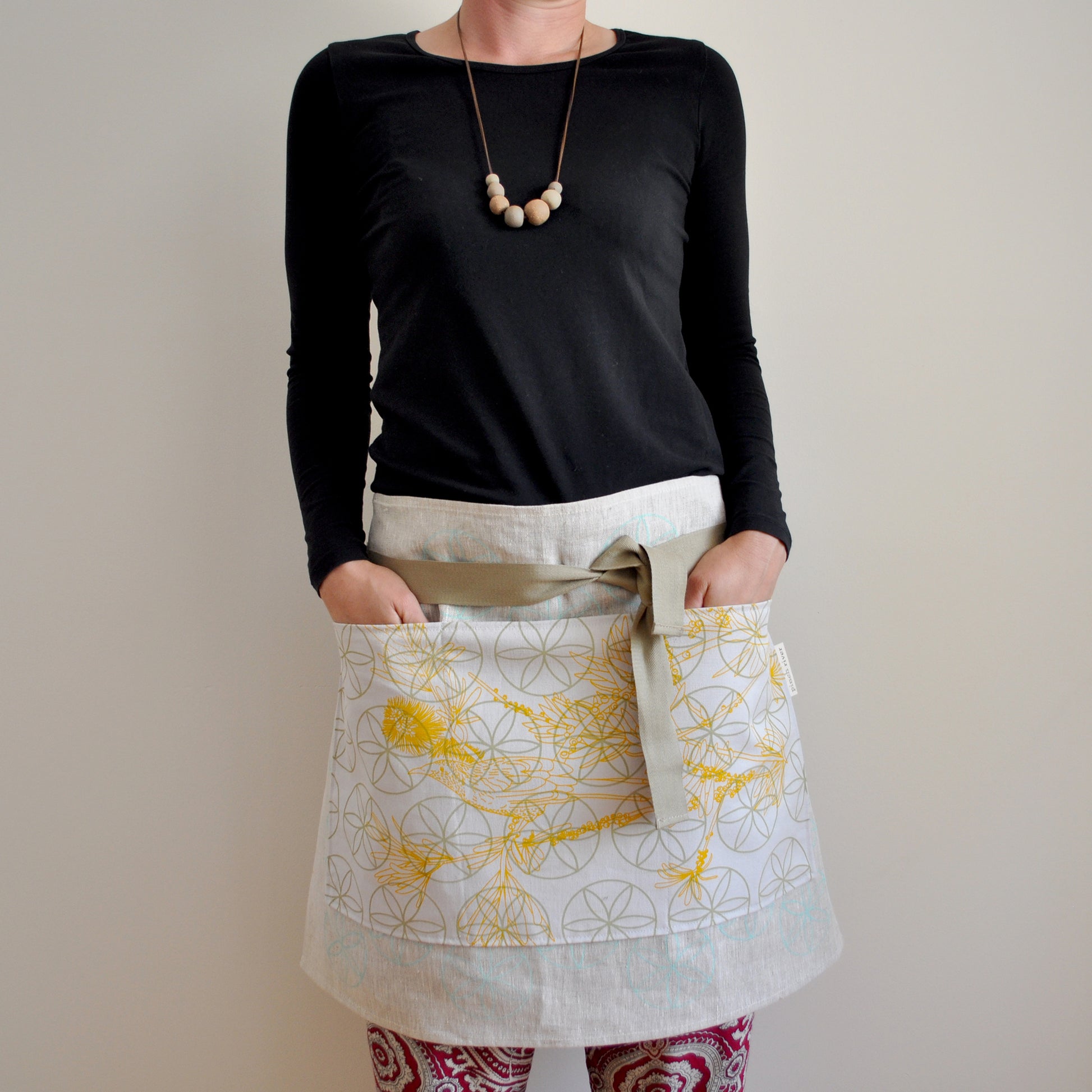 Model wearing Pinch River waist apron / half apron No. 3, against a plain background. Front View.