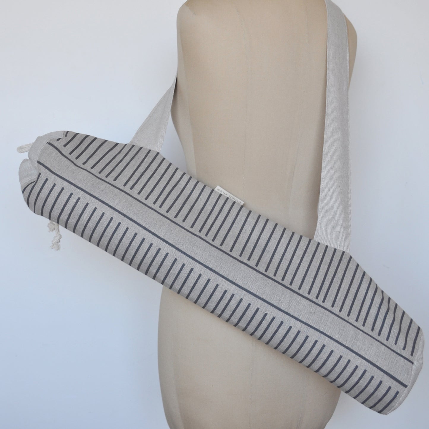 Pinch River yoga mat bag in Corduroy Pathway print in Grey Bark on Natural Linen (colourway 2), on dressmakers dummy. Full view.