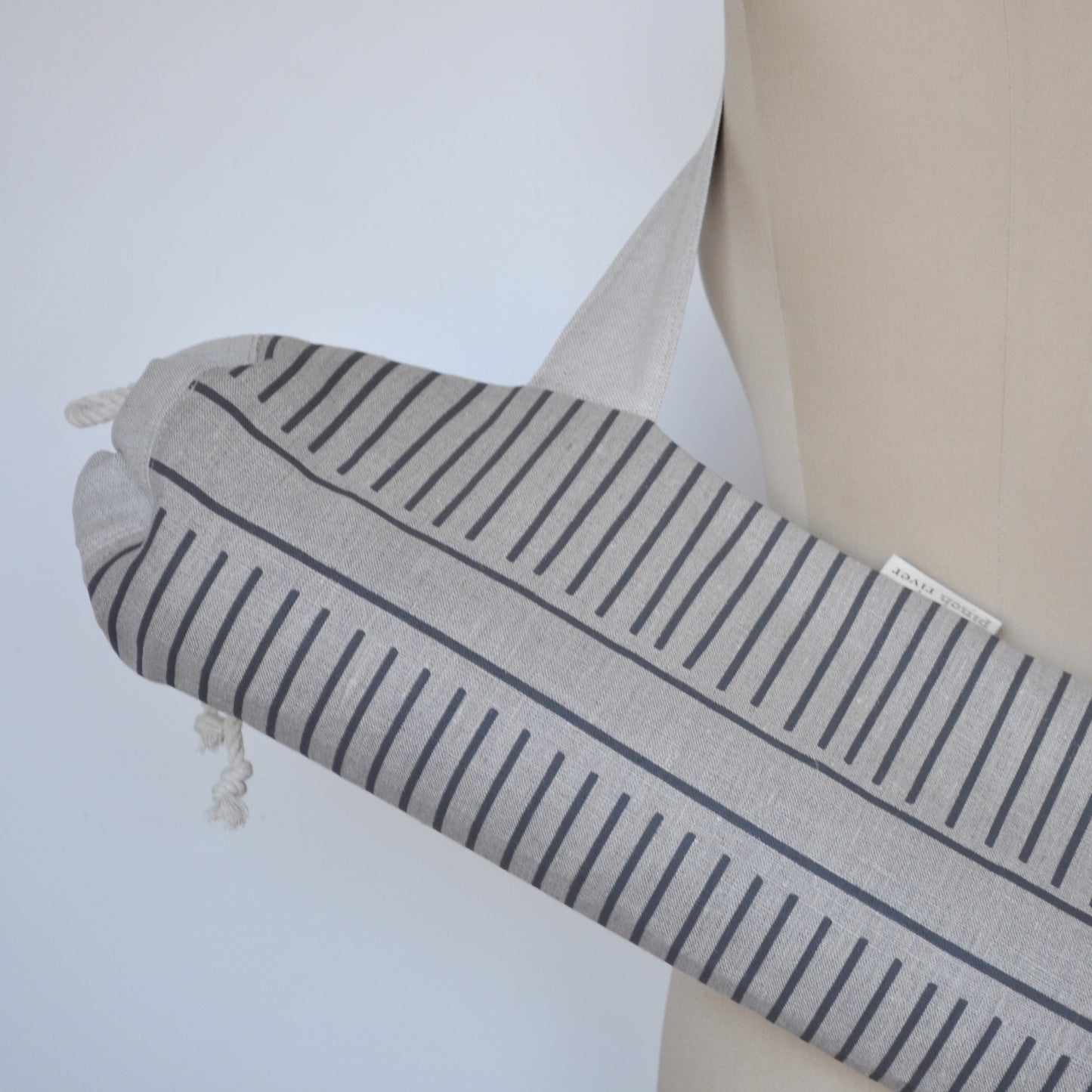 Pinch River yoga mat bag in Corduroy Pathway print in Grey Bark on Natural Linen (colourway 2), on dressmakers dummy. Close-up view.