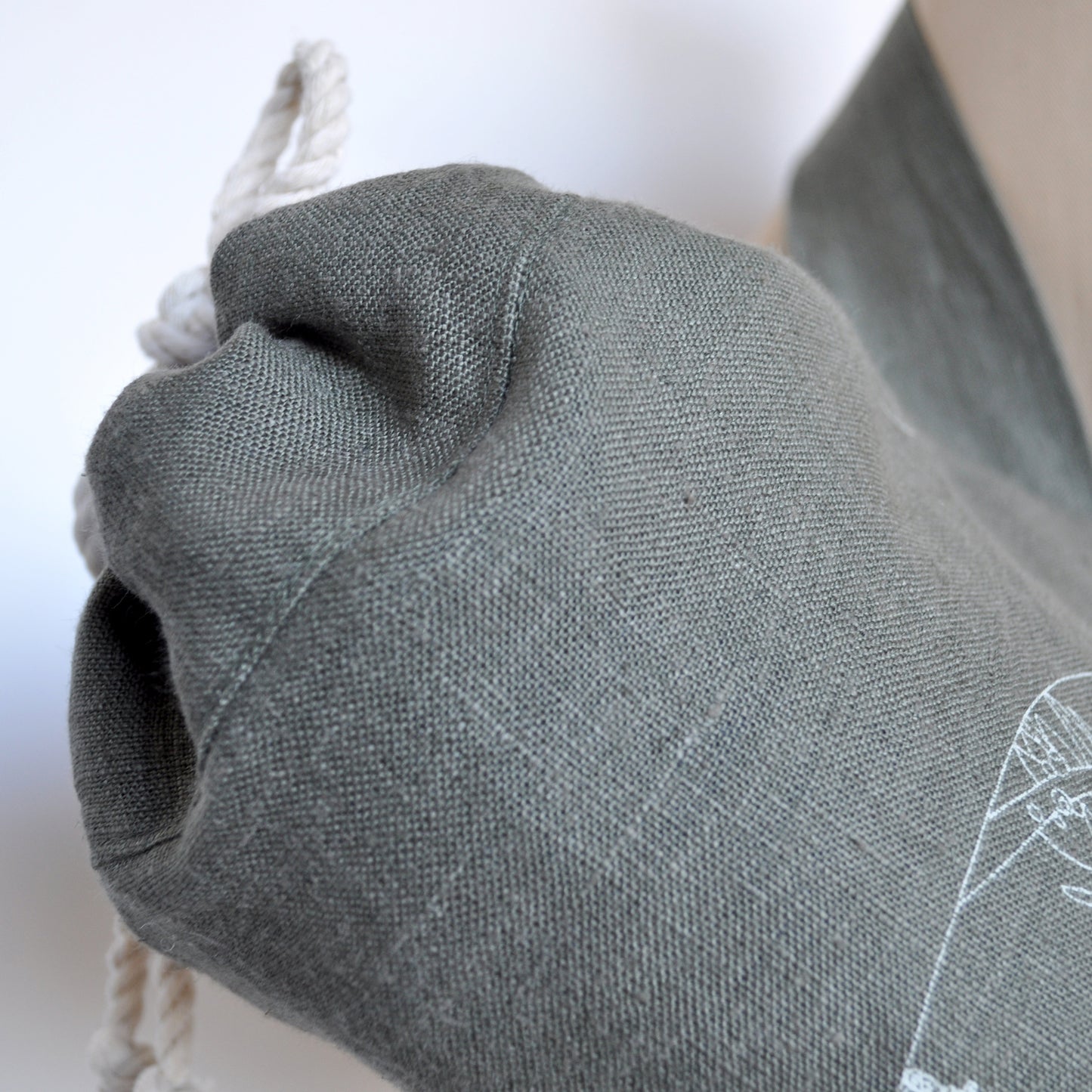 Pinch River yoga mat bag in Wattle Bird in the Bottle Brush print in Moss Green on Forest Green Linen (colourway 3), on dressmakers dummy. Detail view.