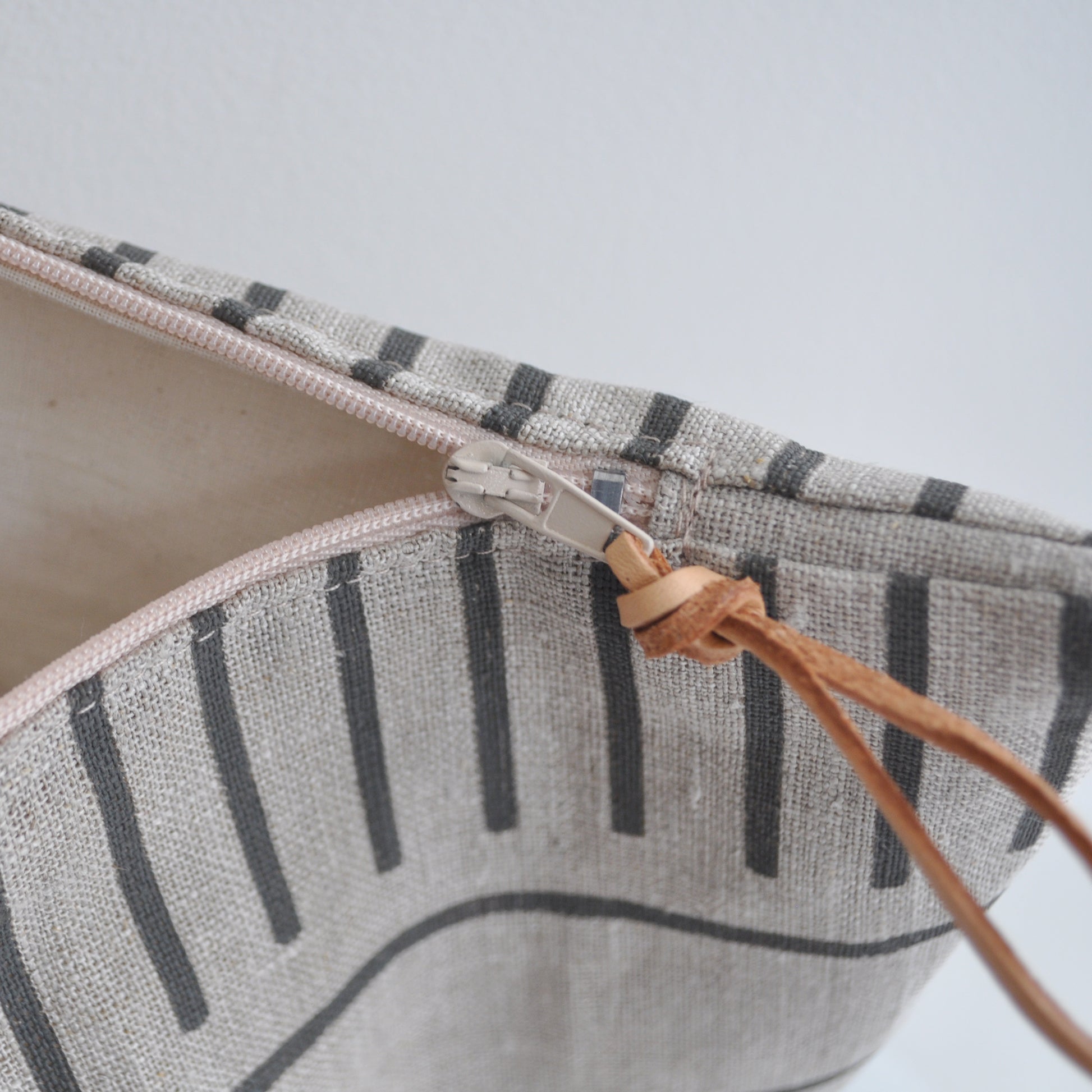 Pinch River zipper pouch featuring Corduroy Pathway print in Gey Bark (colourway 2). Side view with zipper opened to show the pouch is fully lined.