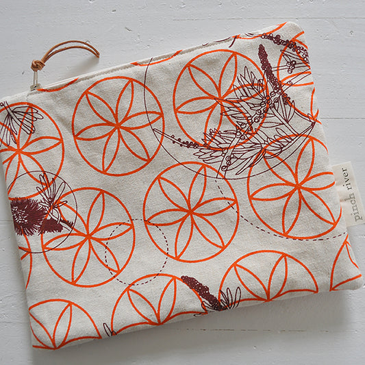 Pinch River zipper pouch featuring Wattle Bird in the Bottle Brush print in Wine Berry (colourway 1) overprinted with Flower of Life print in Fiery Orange (colourway 3). Top view.