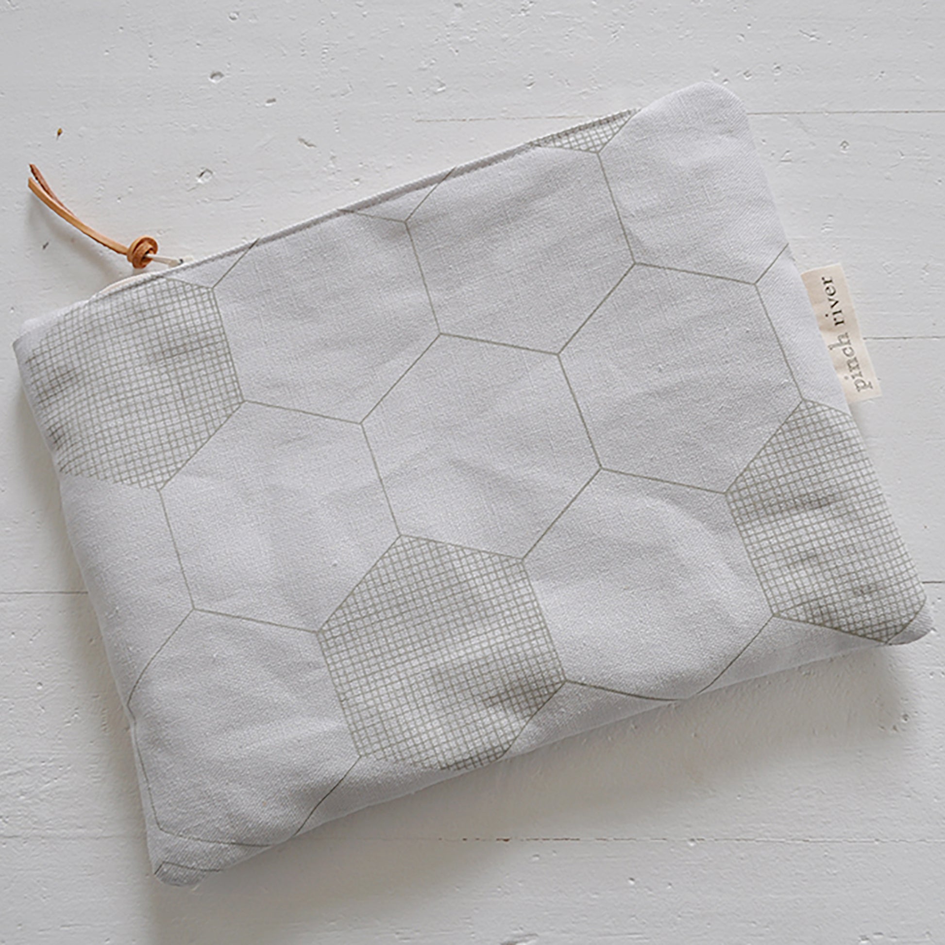 Pinch River zipper pouch featuring Honeycomb print in Moss Green (colourway 1). Top view.