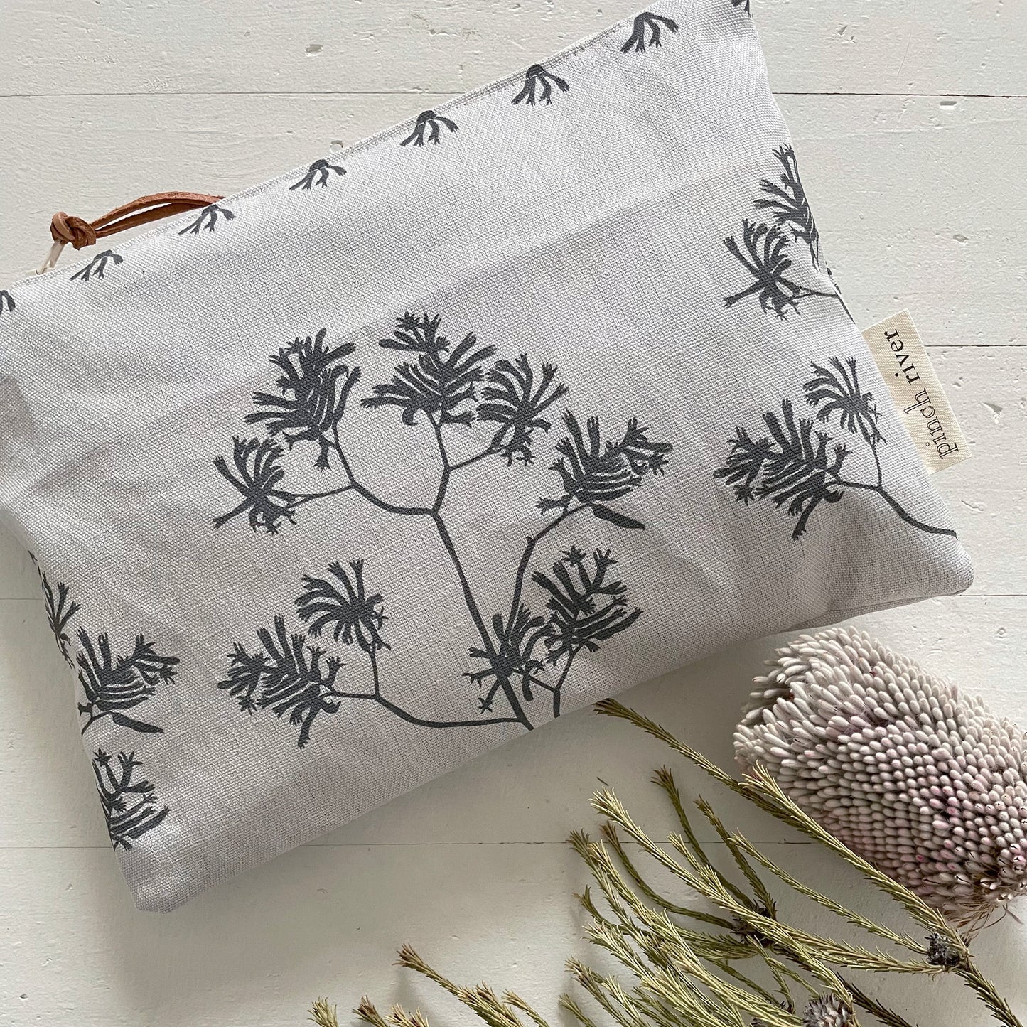 Pinch River zipper pouch featuring Kangaroo Paw print in Tempest (colourway 3_v1). Top view. Product image is styled with Australian native flora.