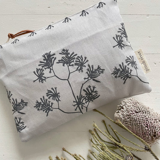 Pinch River zipper pouch featuring Kangaroo Paw print in Tempest (colourway 3_v1). Top view. Product image is styled with Australian native flora.