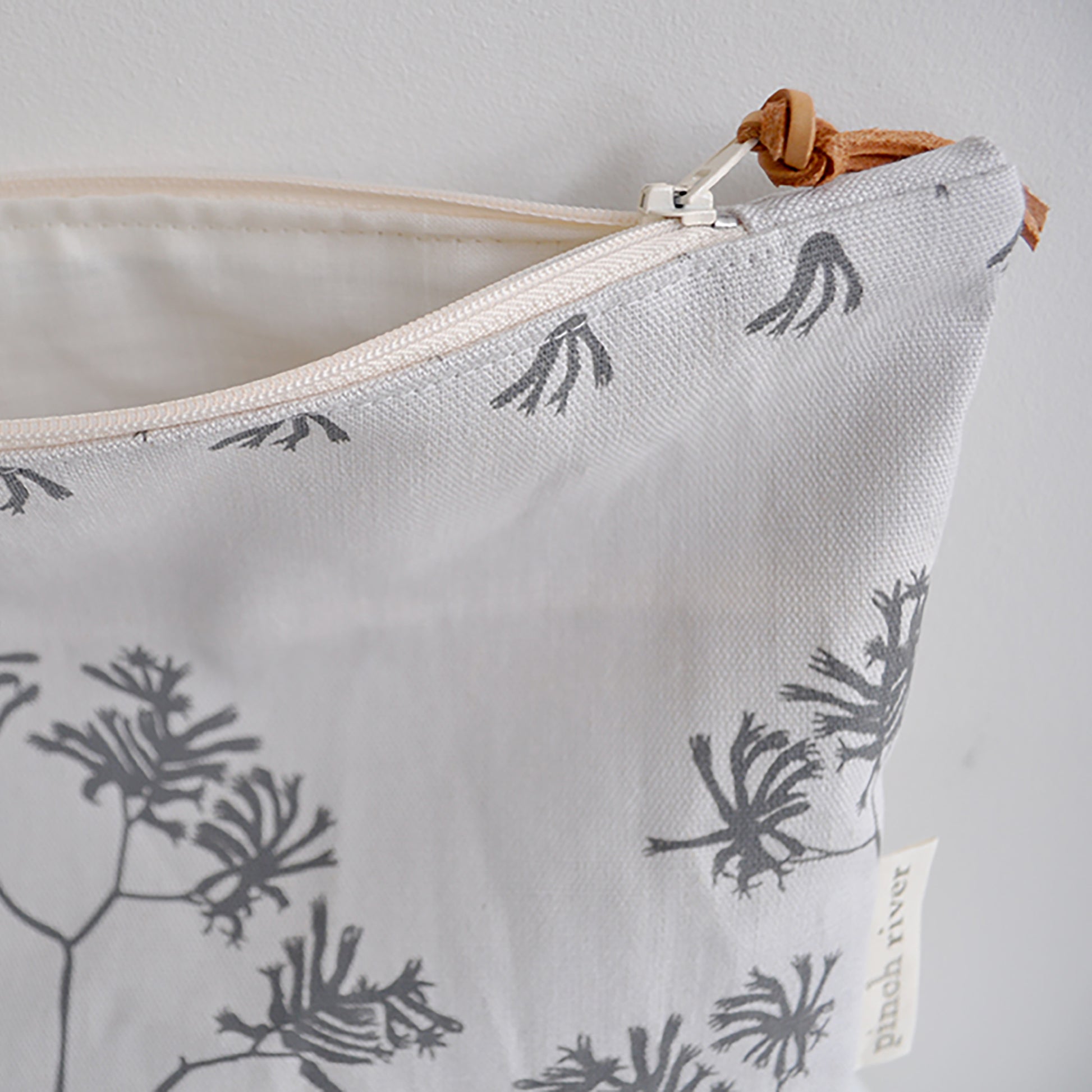 Pinch River zipper pouch featuring Kangaroo Paw print in Tempest (colourway 3_v1). Side view with zipper opened to show the pouch is fully lined.