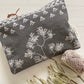 Pinch River zipper pouch featuring Kangaroo Paw print in Tempest (colourway 3_v2). Top view. Product image is styled with Australian native flora.