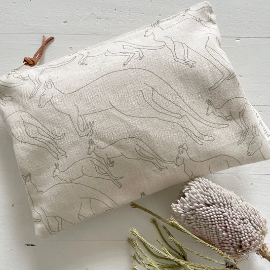Pinch River zipper pouch featuring Kangaroos print in Moss Green (colourway 2). Top view. Product image is styled with Australian native flora.