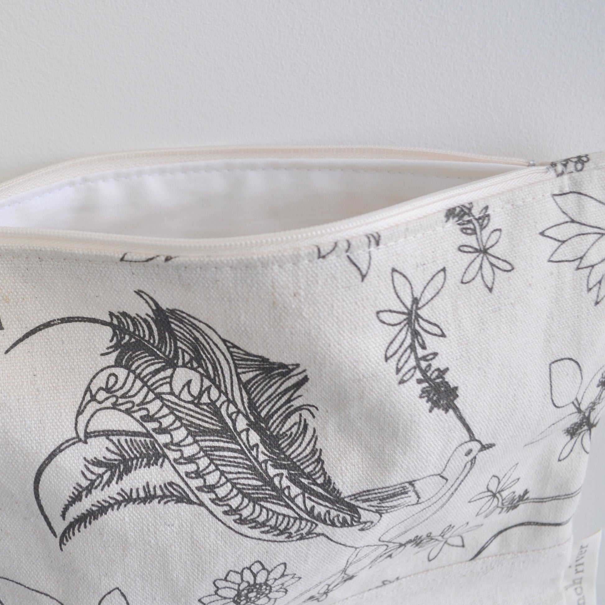 Pinch River zipper pouch featuring Lyrebird print in Gey Bark (colourway 1). Side view with zipper opened to show the pouch is fully lined.