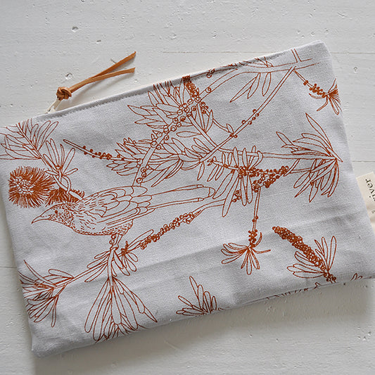 Pinch River zipper pouch featuring Wattle Bird print in Burnt Orange (colourway 2). Top view. 