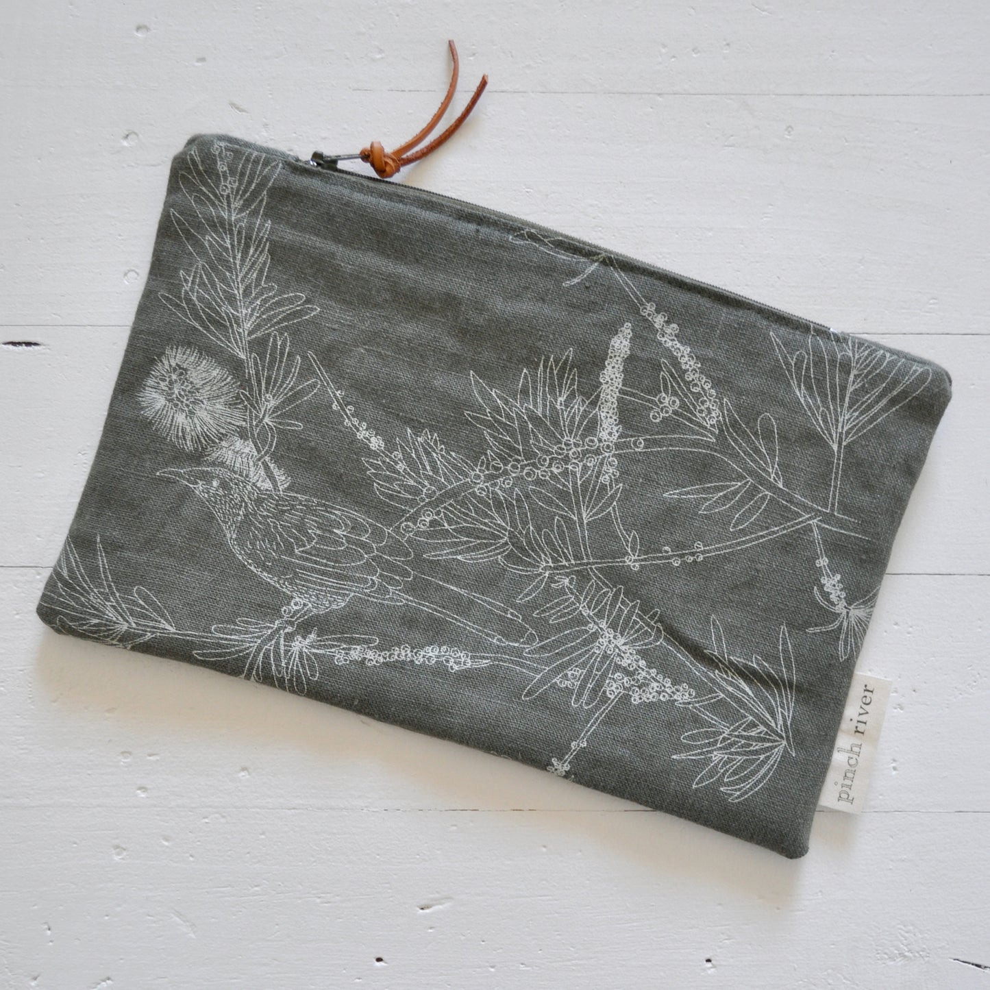Pinch River zipper pouch featuring Wattle Bird print in Moss Green (colourway 3). Top view.